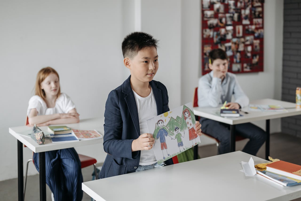 Child showcasing drawing in a classroom setting, focusing on education.